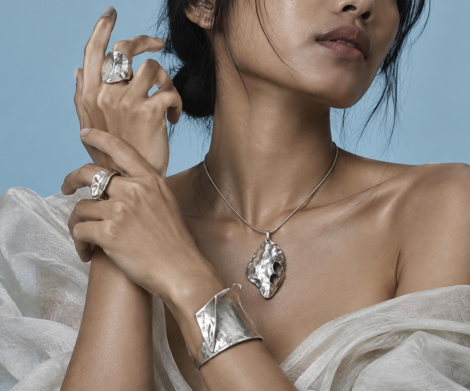Hammered silver rings, pendant, and cuff